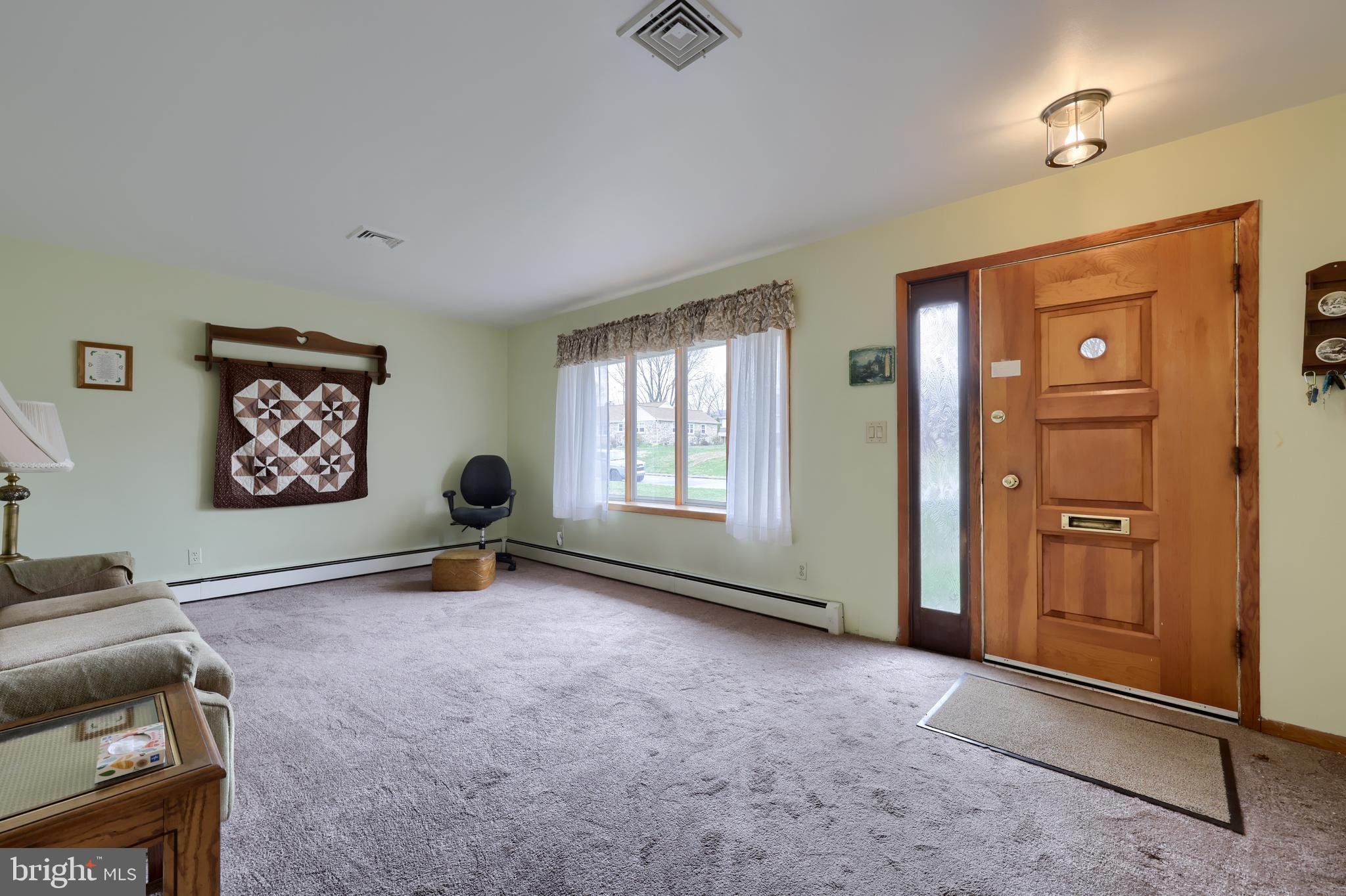 3916 Grant Street Reading, PA 19606 - Photo 14 of 39 a view of a livingroom with a flesh screen tv and windows