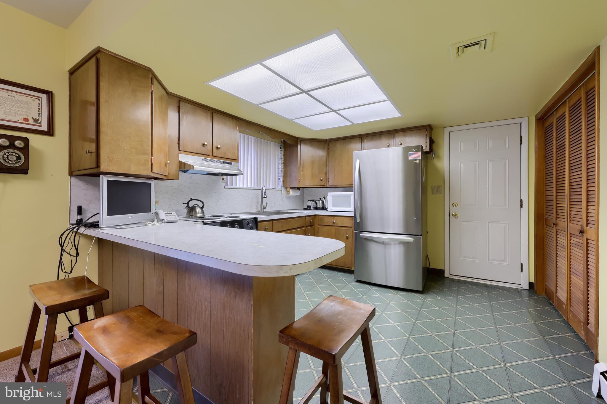 3916 Grant Street Reading, PA 19606 - Photo 20 of 39 a kitchen with stainless steel appliances a stove a refrigerator and a sink