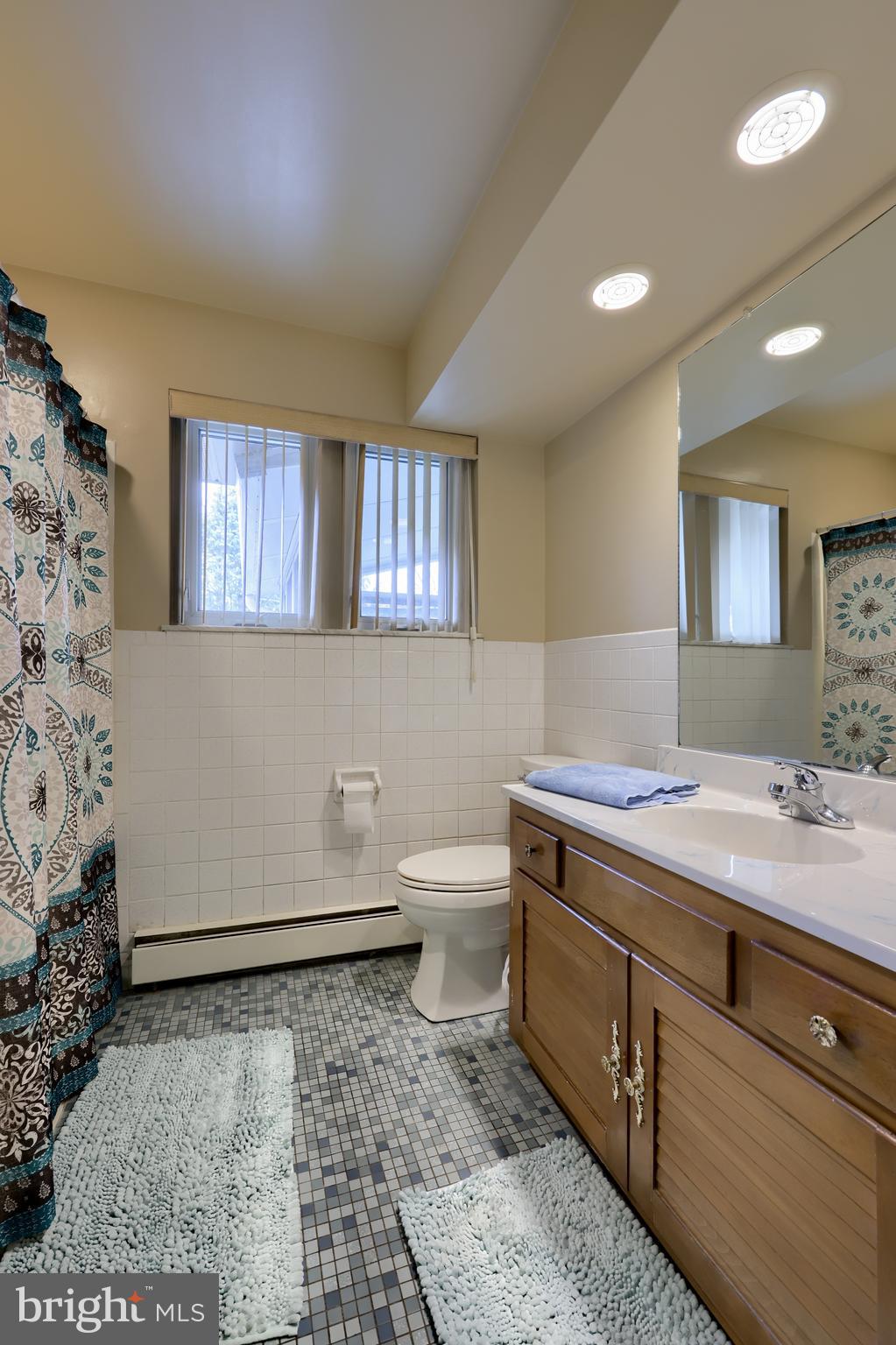 3916 Grant Street Reading, PA 19606 - Photo 27 of 39 a bathroom with a sink a toilet and mirror