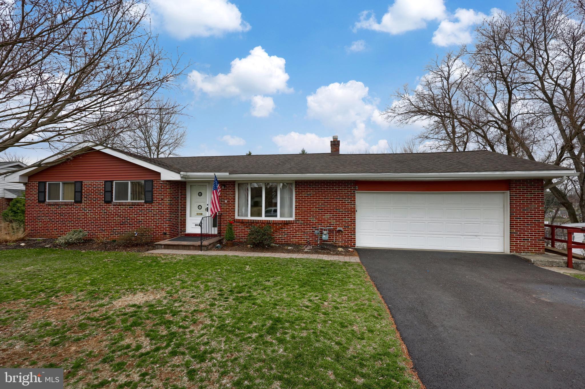 3916 Grant Street Reading, PA 19606 - Photo 9 of 39 a front view of a house with a yard and garage
