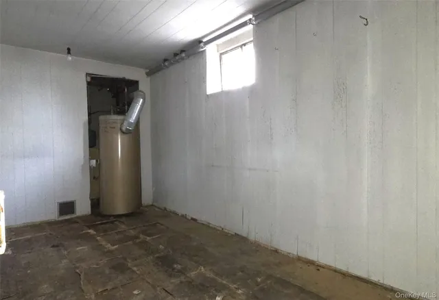 a storage room with wooden floor and white walls