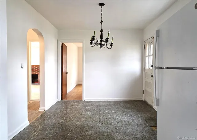 a view of a room with wooden floor and windows
