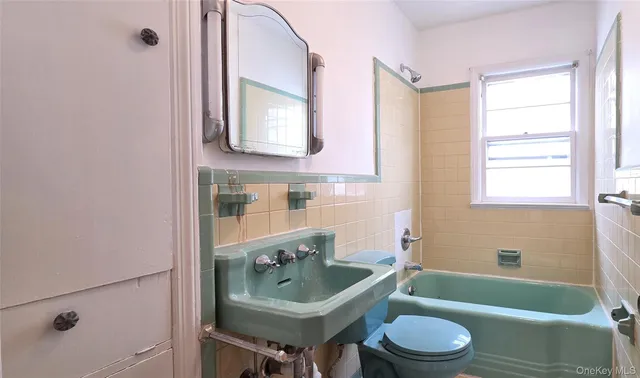 a bathroom with a sink toilet tub and shower