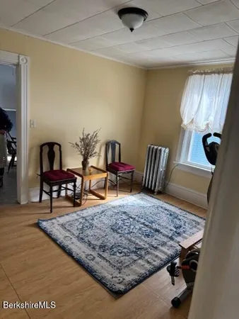 a living room with couch and a rug