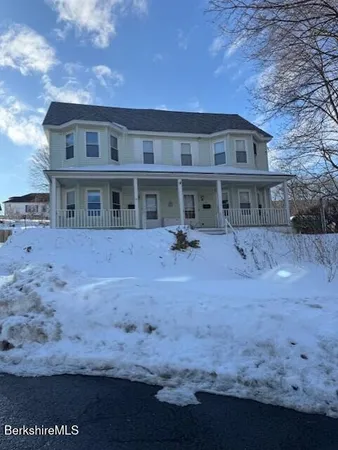 a view of a house with a backyard