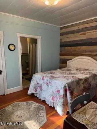 a bedroom with a bed and a mirror