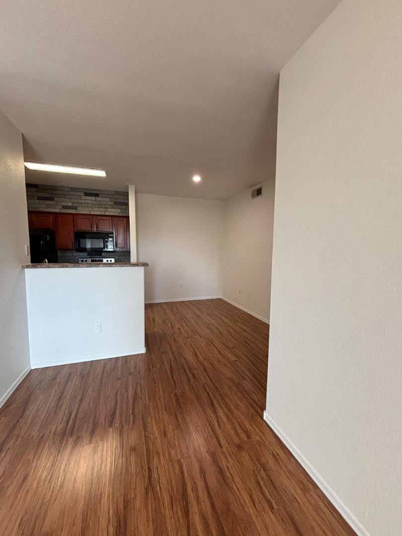 3302 North 7th Street, Unit 335 Phoenix, AZ 85014 - Photo 5 of 14 a view of a room with wooden floor