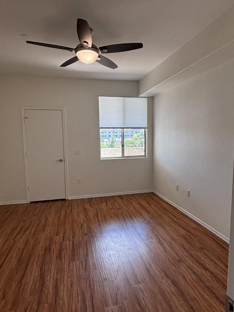 3302 North 7th Street, Unit 335 Phoenix, AZ 85014 - Photo 6 of 14 a view of an empty room with wooden floor and a window