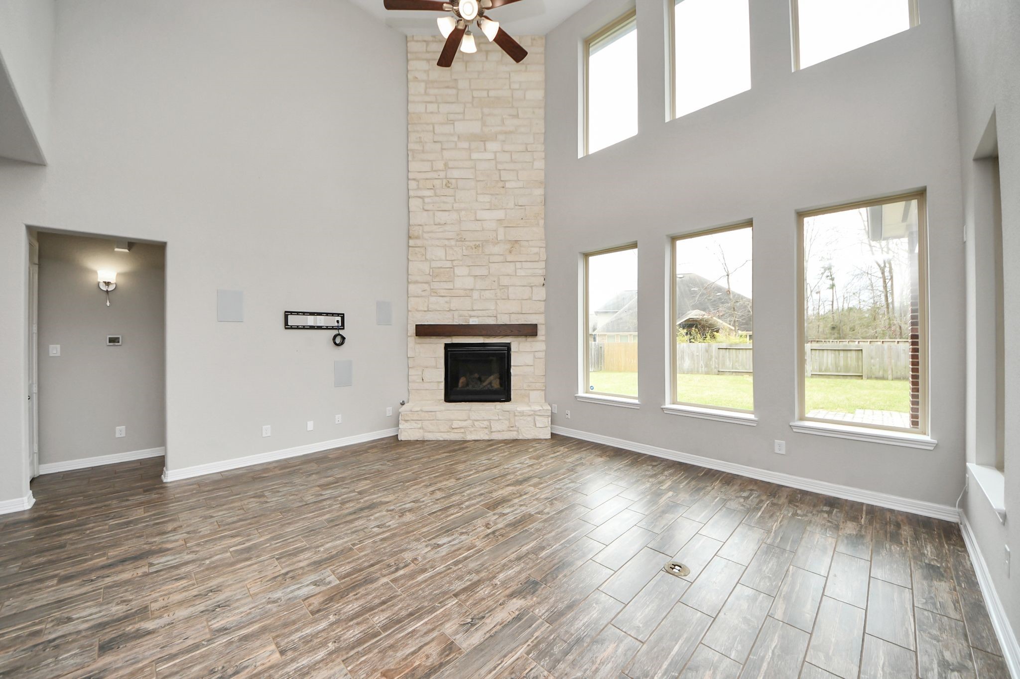 6002 Granite Shadow Lane Houston, TX 77365 - Photo 11 of 49 an empty room with wooden floor and windows