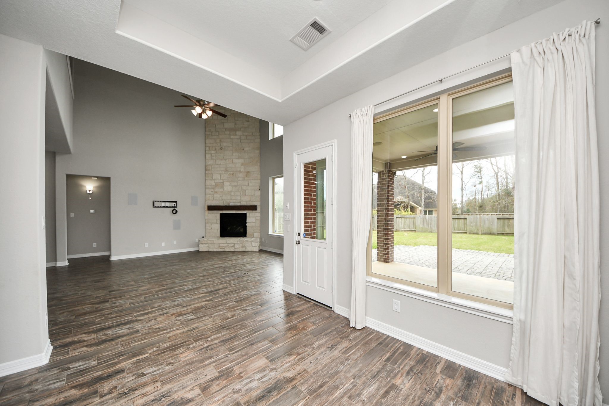 6002 Granite Shadow Lane Houston, TX 77365 - Photo 17 of 49 a view of an empty room with a fireplace and a window