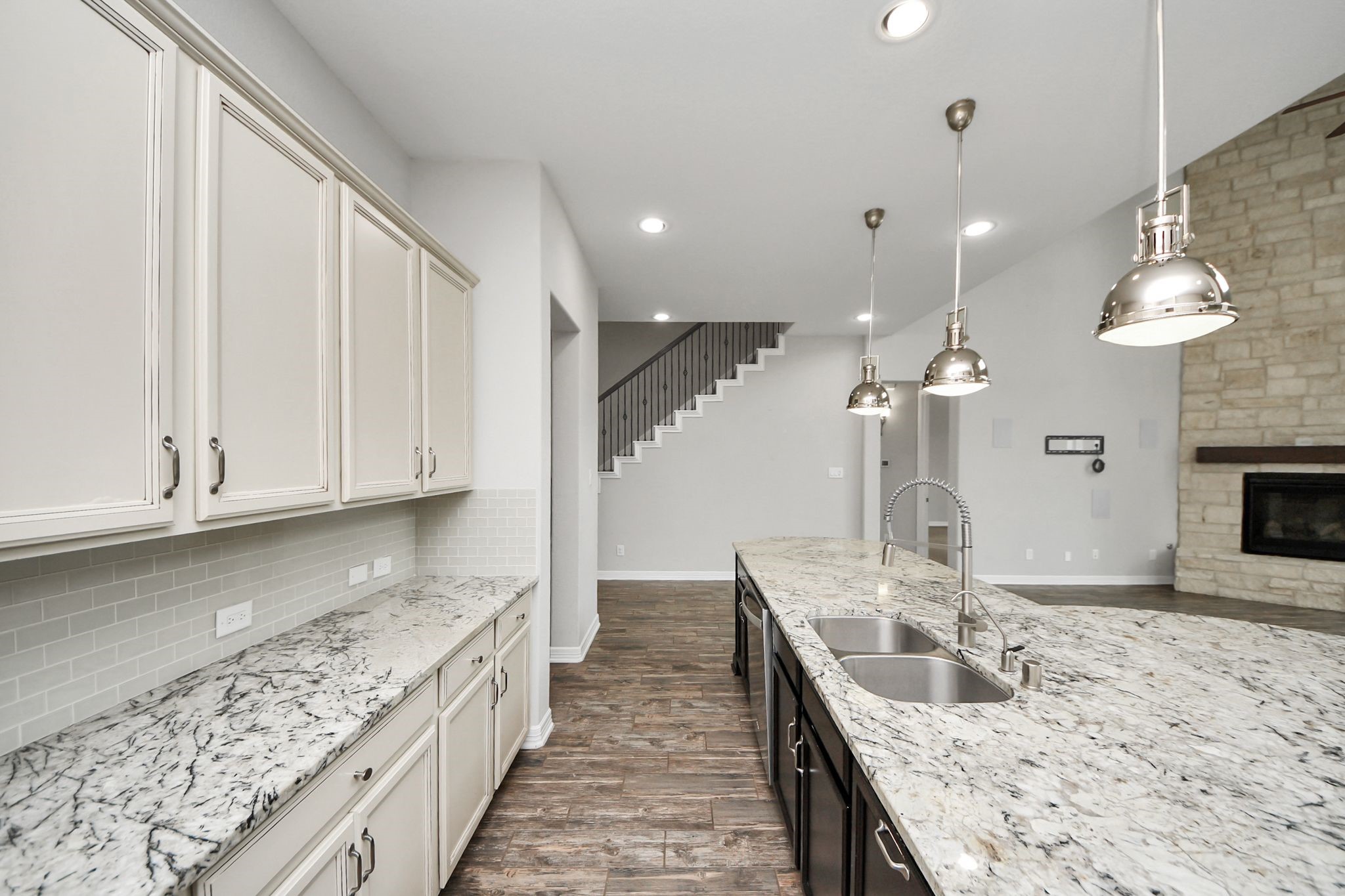 6002 Granite Shadow Lane Houston, TX 77365 - Photo 19 of 49 a large kitchen with granite countertop a sink a counter top space and cabinets