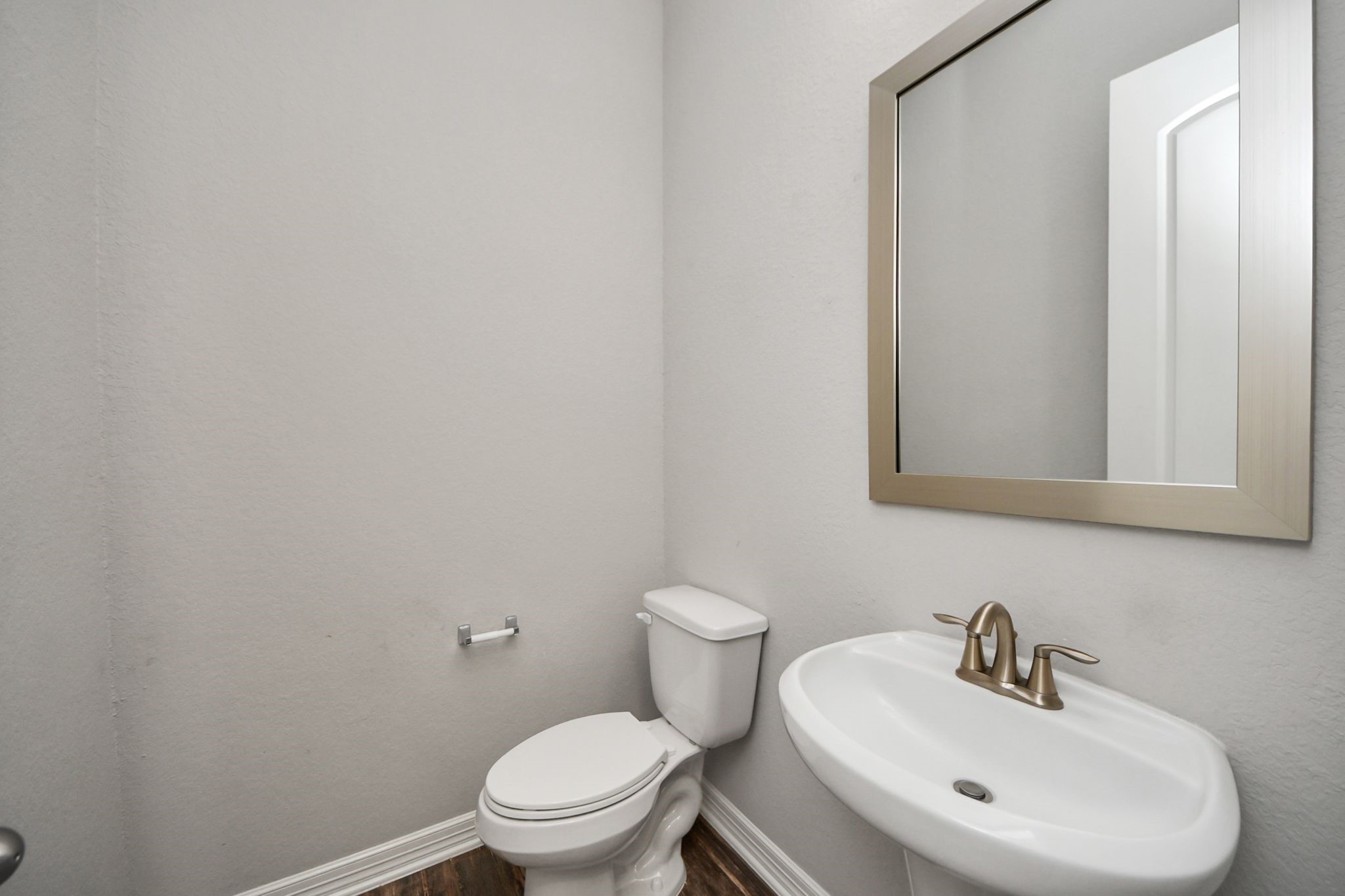 6002 Granite Shadow Lane Houston, TX 77365 - Photo 21 of 49 a bathroom with a sink a mirror and a toilet