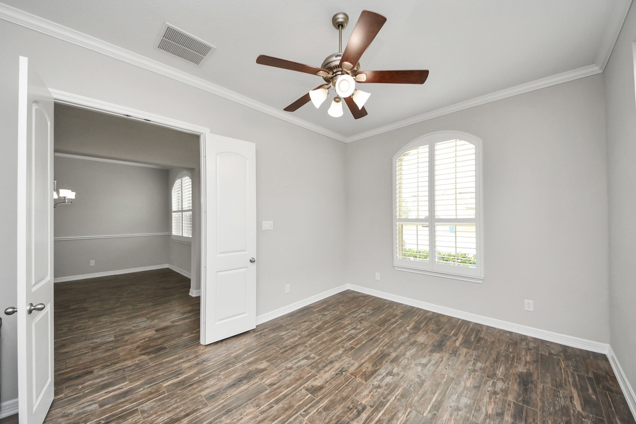 6002 Granite Shadow Lane Houston, TX 77365 - Photo 45 of 49 a view of an empty room with wooden floor and a window