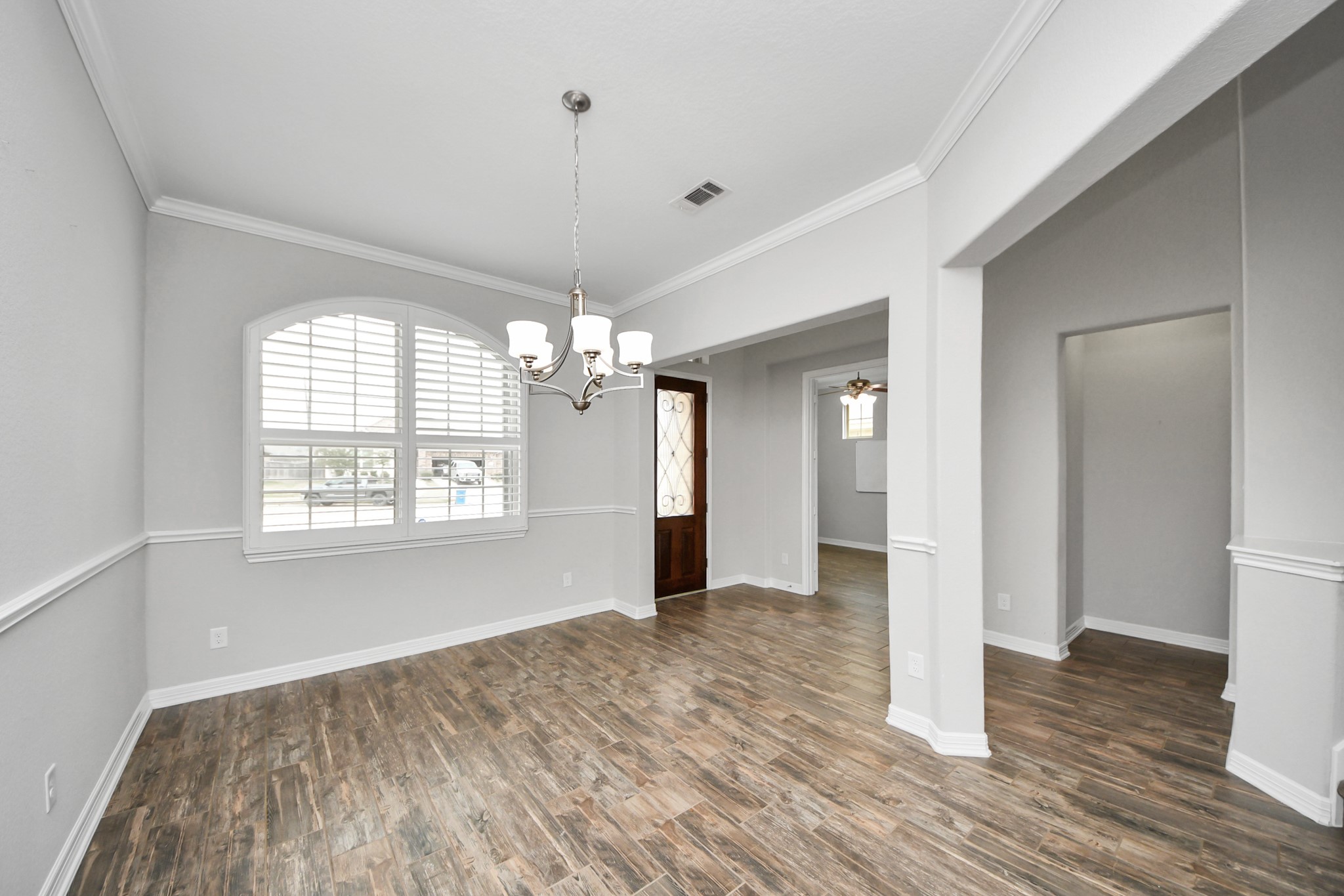6002 Granite Shadow Lane Houston, TX 77365 - Photo 6 of 49 a view of an empty room with wooden floor and a window
