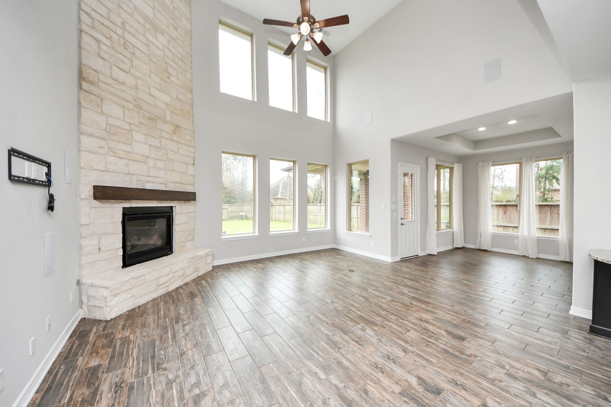 6002 Granite Shadow Lane Houston, TX 77365 - Photo 10 of 49 a view of an empty room with window and wooden floor