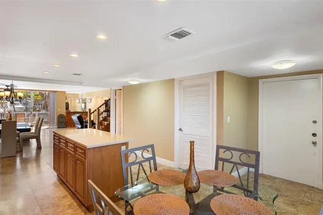 a living room with furniture a flat screen tv and a large window