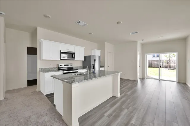 a kitchen with a sink stove and microwave