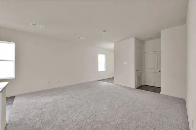 a view of an empty room with windows