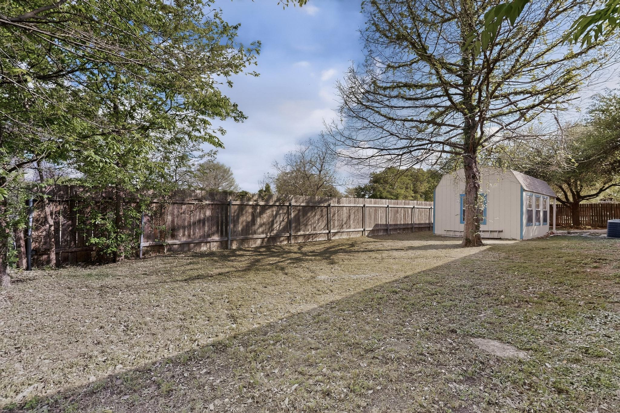 812 George Street Taylor, TX 76574 - Photo 28 of 34 Fenced backyard with a shed