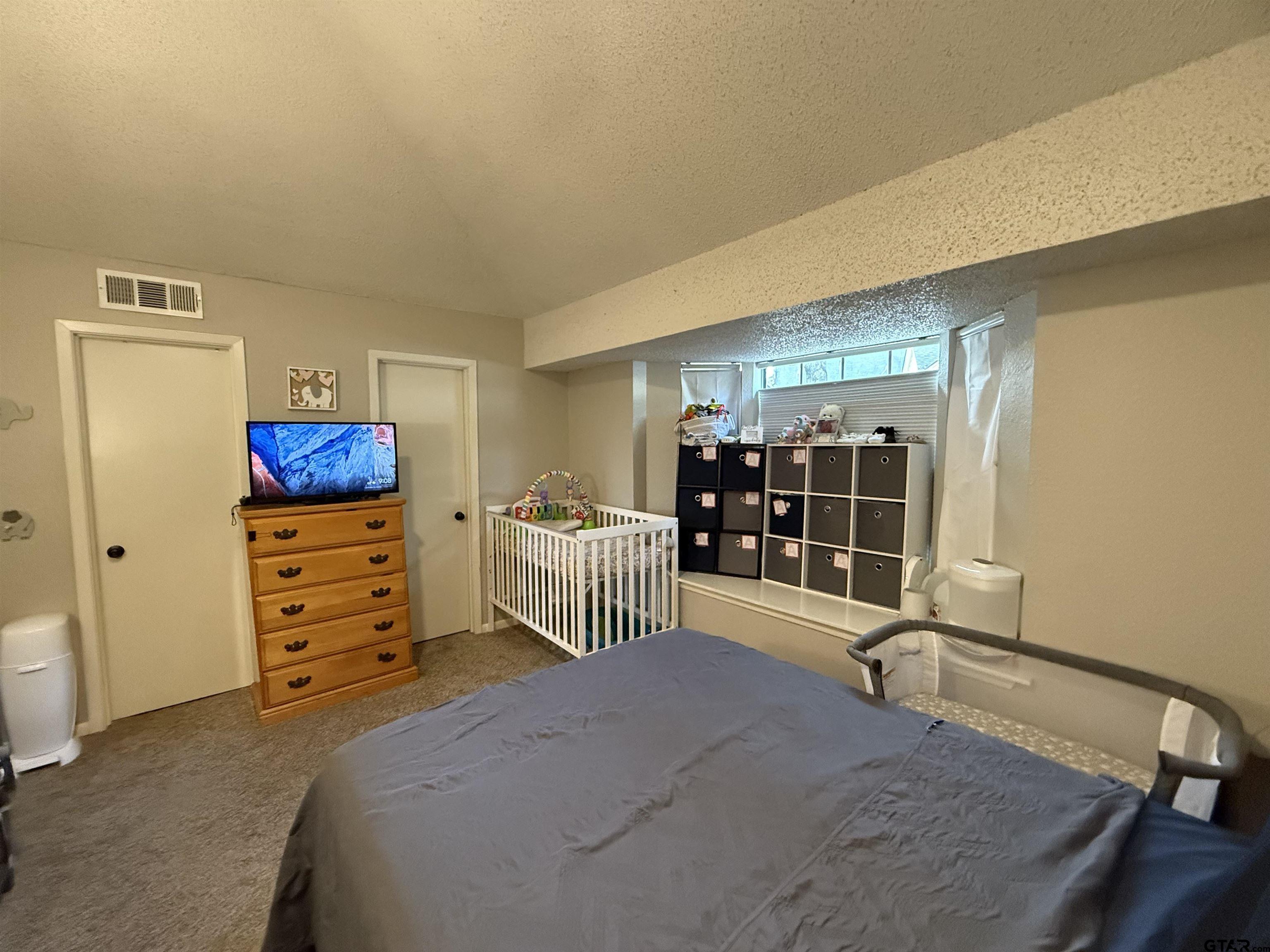 1740 Mill Creek Drive Tyler, TX 75703 - Photo 12 of 19 a bedroom with furniture and a window
