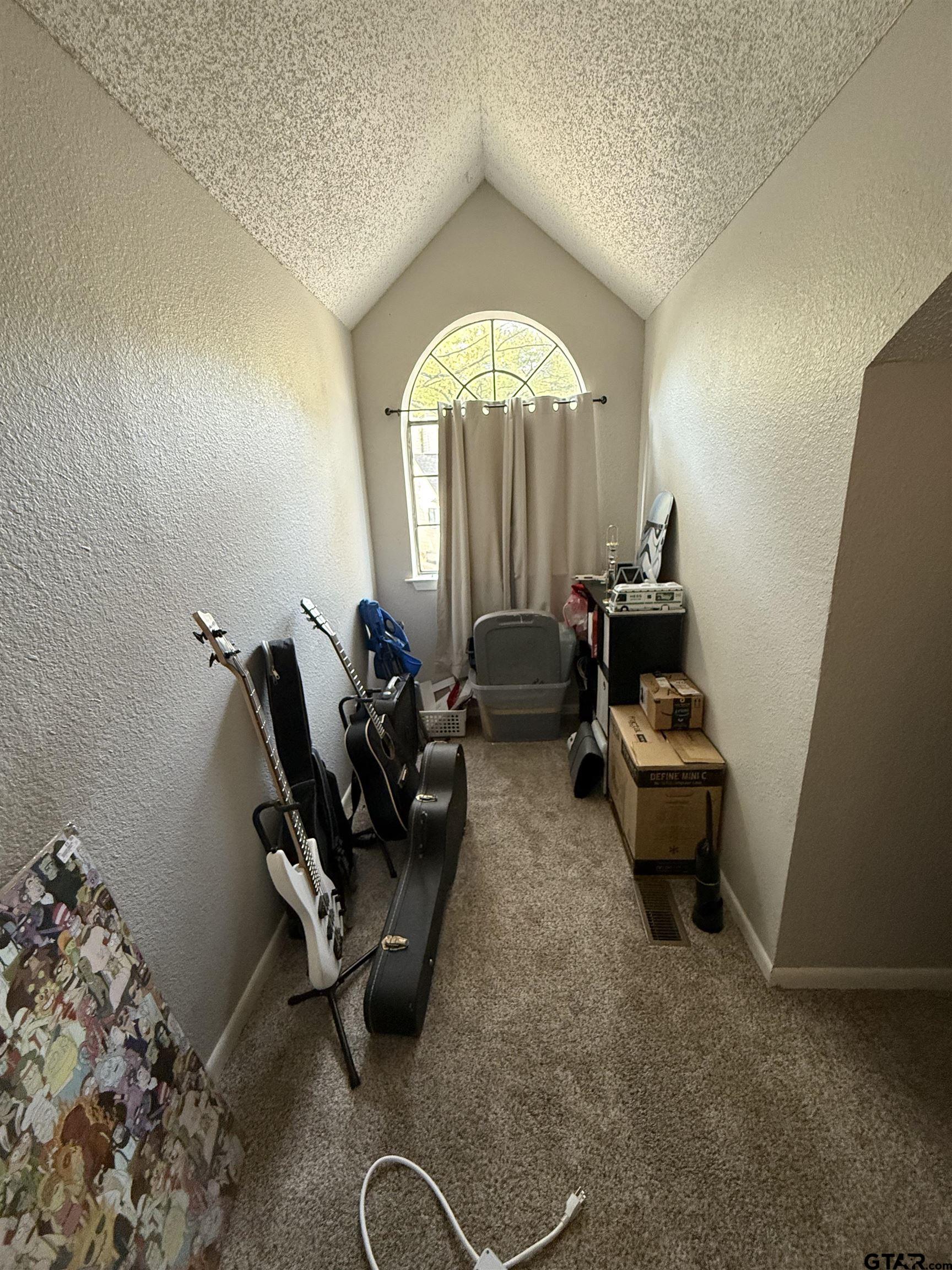 1740 Mill Creek Drive Tyler, TX 75703 - Photo 15 of 19 a living room with furniture gym equipment and a large window