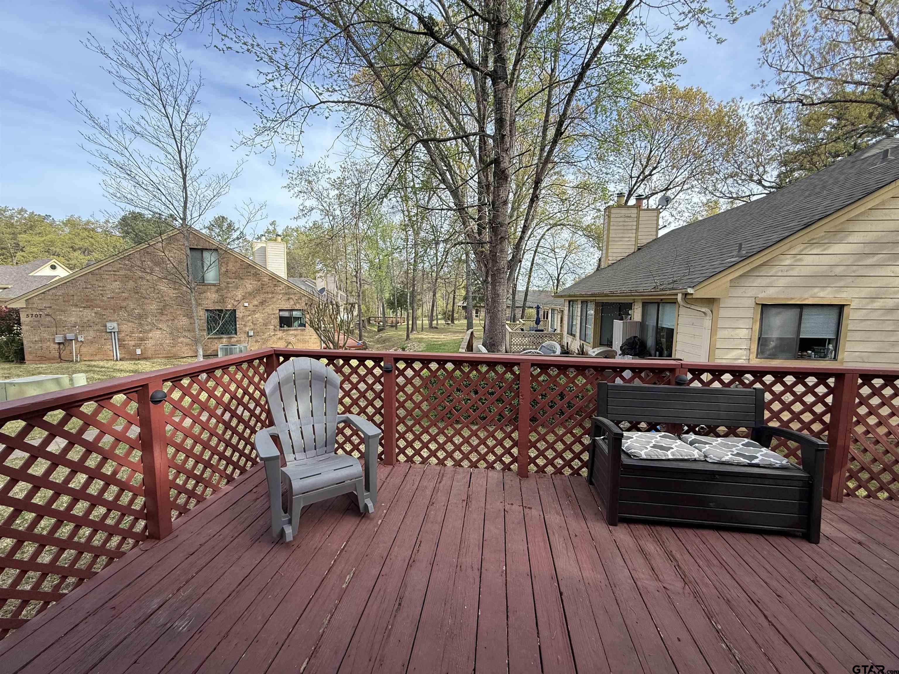 1740 Mill Creek Drive Tyler, TX 75703 - Photo 17 of 19 a view of a roof deck with wooden floor and fence
