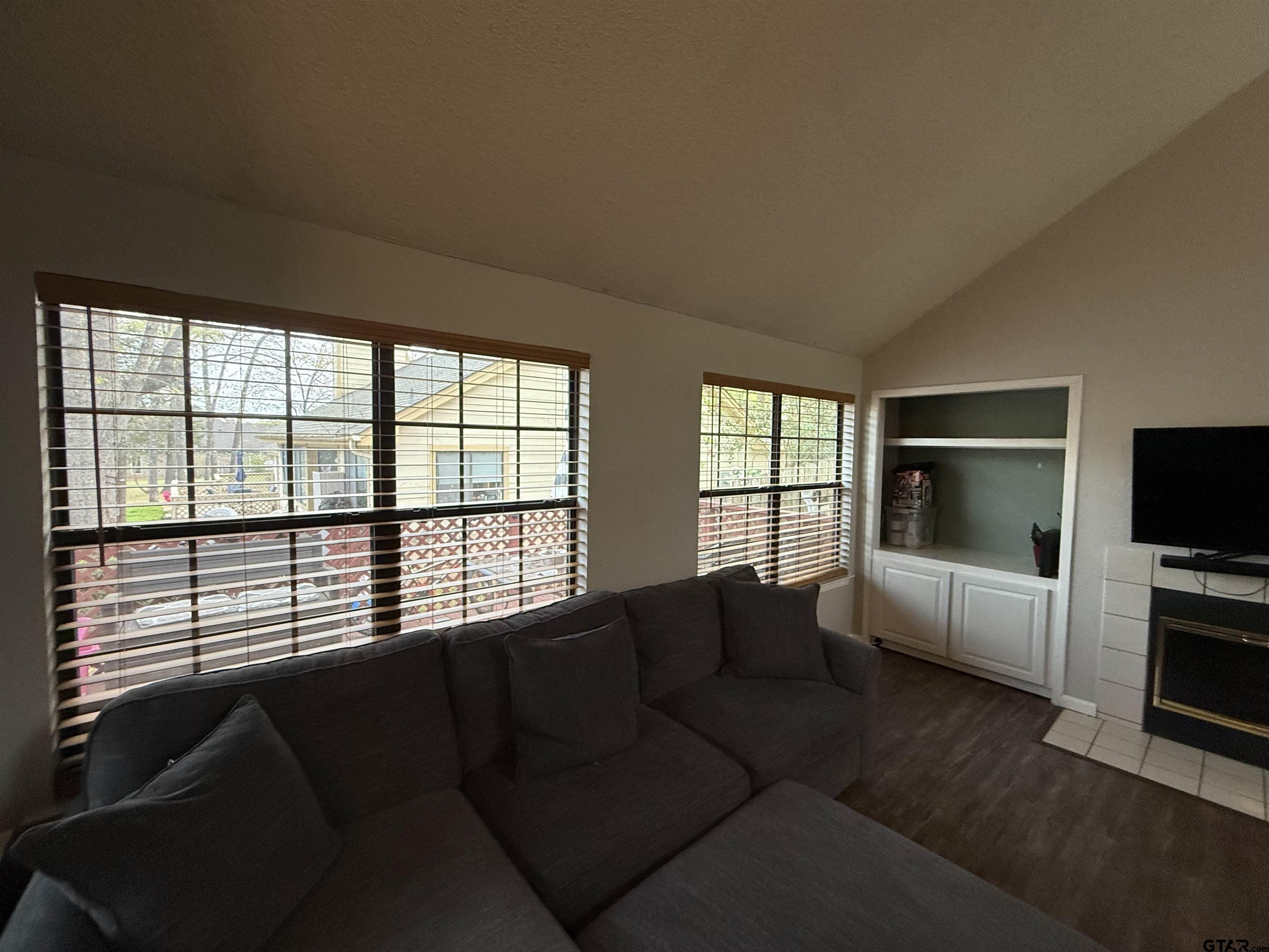 1740 Mill Creek Drive Tyler, TX 75703 - Photo 7 of 19 a living room with furniture and a flat screen tv