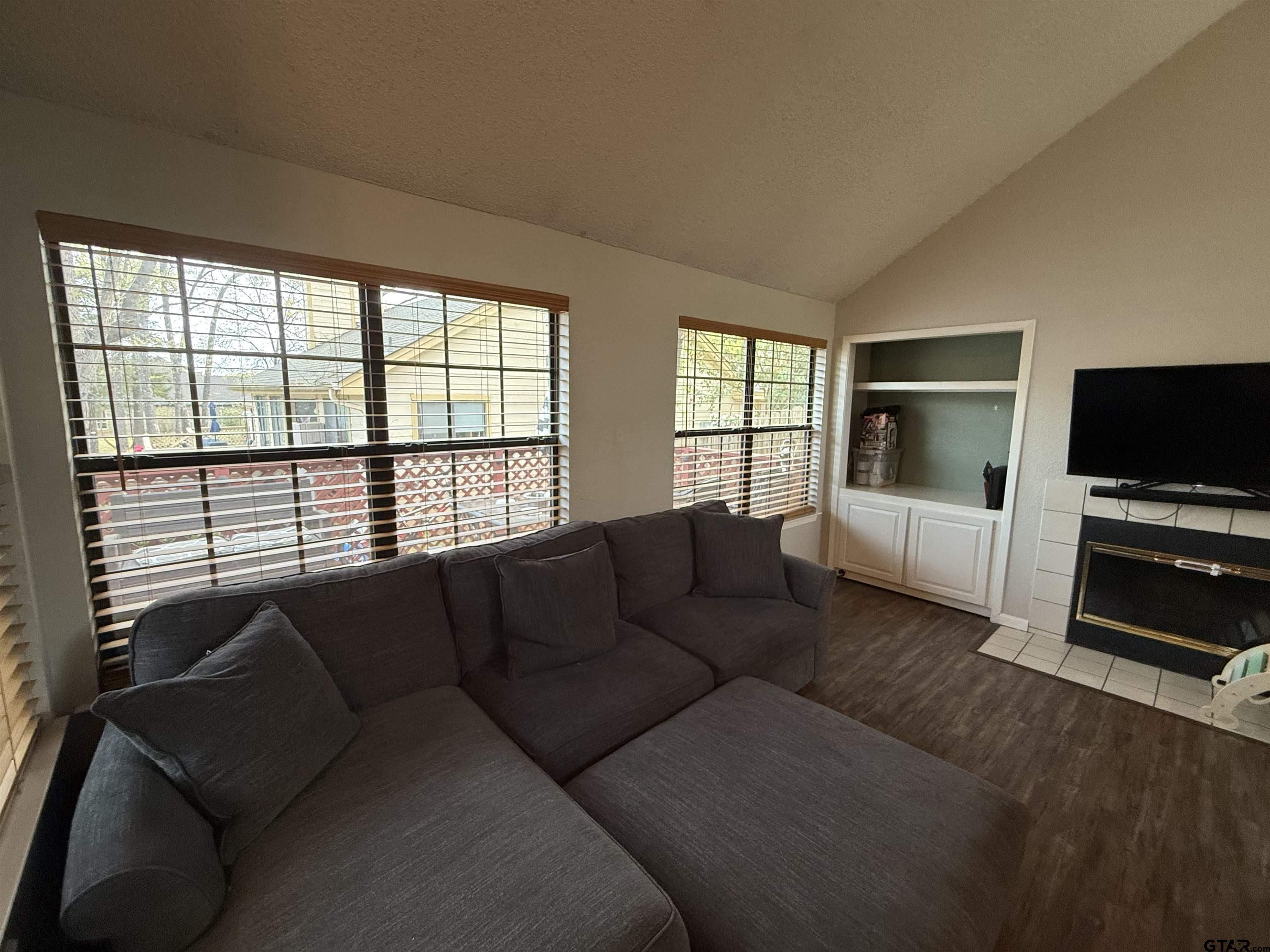 1740 Mill Creek Drive Tyler, TX 75703 - Photo 8 of 19 a living room with furniture and a flat screen tv