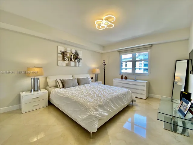 a bedroom with a bed and a lamp on table