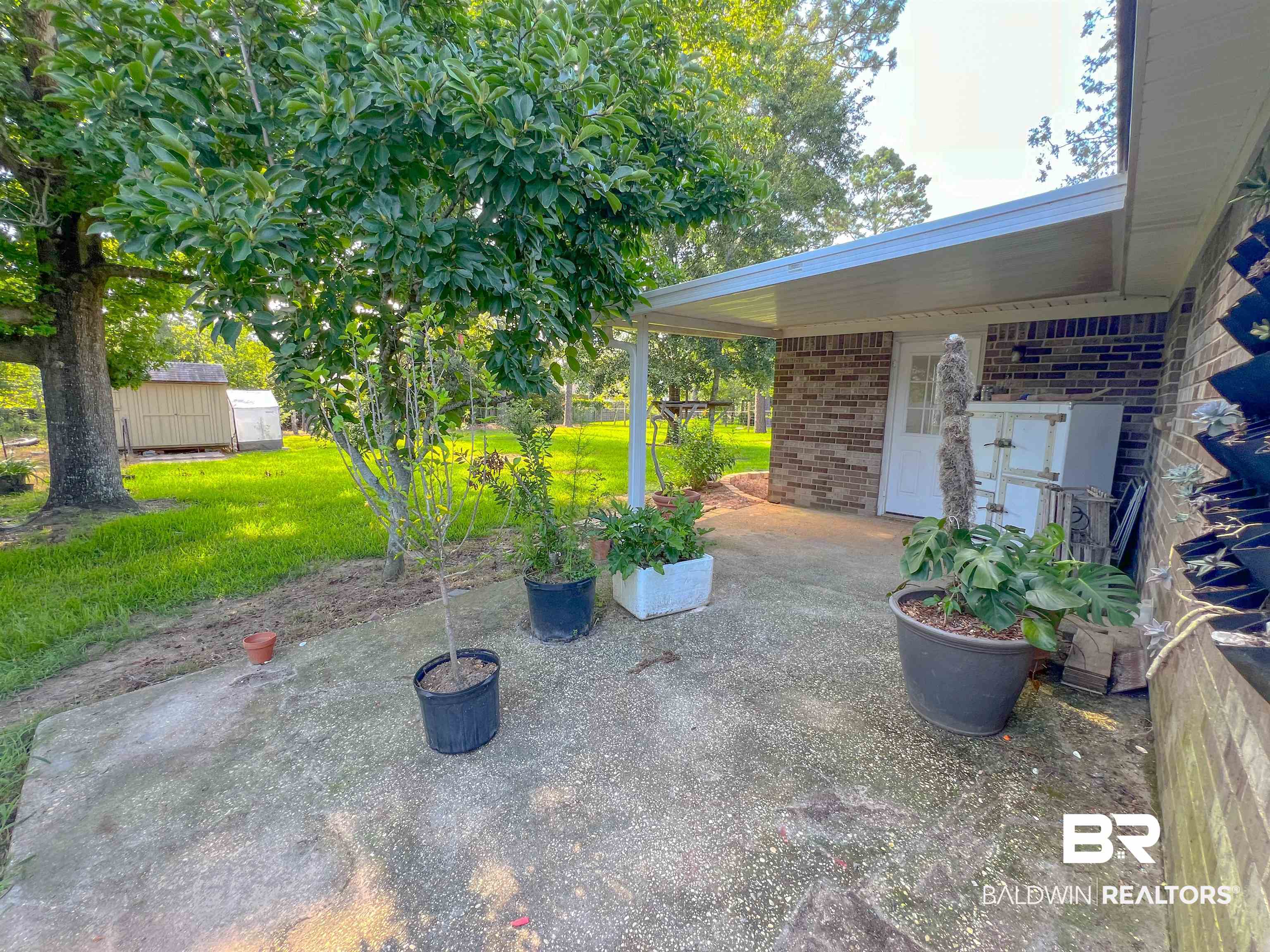 1200 South Juniper Street Foley, AL 36535 - Photo 21 of 23 View of yard with a shed and a patio