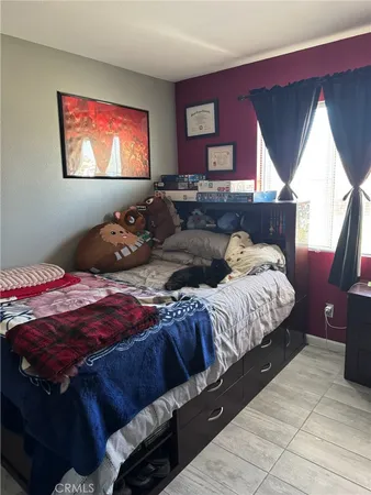 a bedroom with bed and window