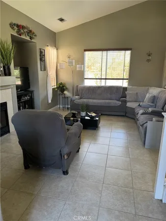 a living room with furniture gym equipment and a window