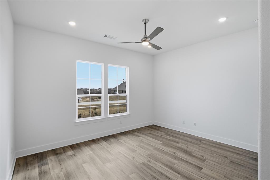 808 Vly Rdg Road Van Alstyne, TX 75495 - Photo 28 of 39 an empty room with wooden floor cabinet and windows