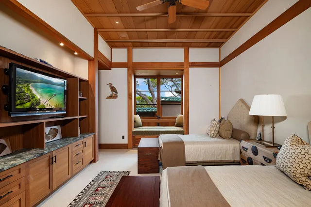 a bedroom with furniture and a flat screen tv