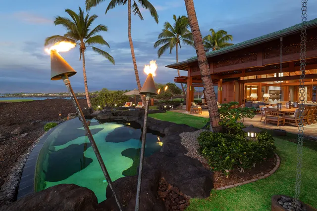 a view of a house with backyard porch and sitting area