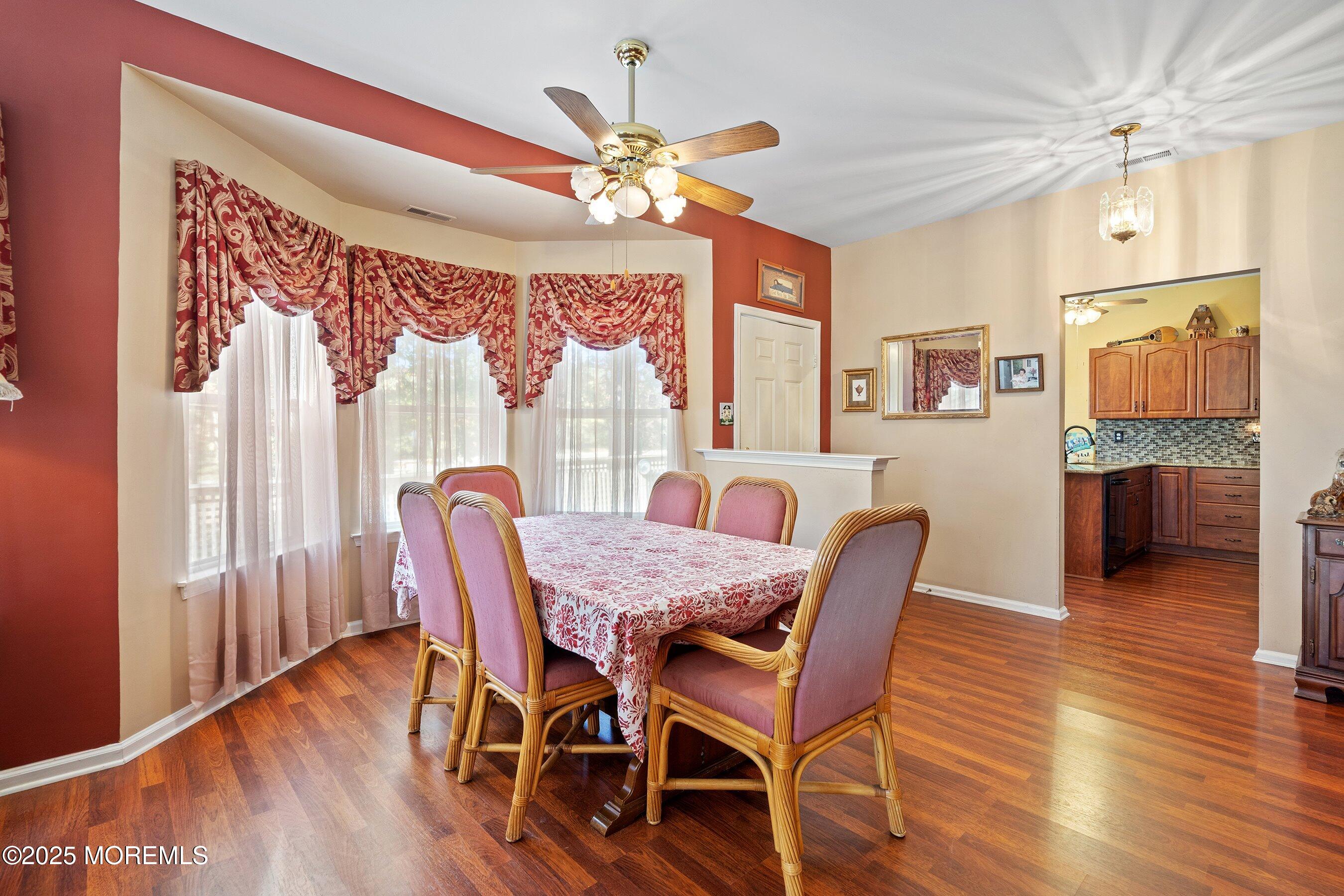 10 Hampton Road Manahawkin, NJ 08050 - Photo 11 of 38 a view of a dining room with furniture window and wooden floor