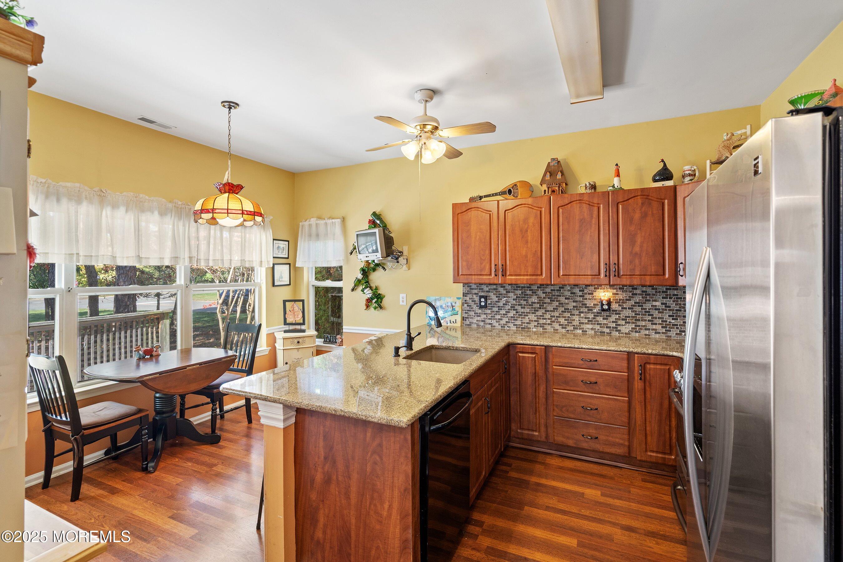 10 Hampton Road Manahawkin, NJ 08050 - Photo 5 of 38 a kitchen with a sink dishwasher and a refrigerator with wooden floor