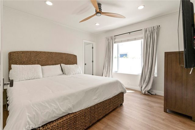 a bedroom with a bed closet and flat tv screen