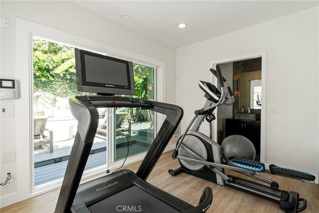 a room with gym equipment and windows