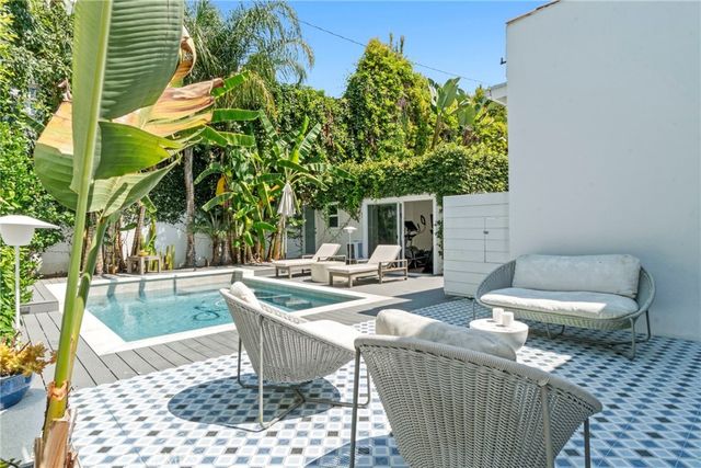 a view of a patio with table and chairs and potted plants