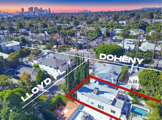 an aerial view of residential houses with outdoor space and street view