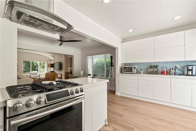 a kitchen with a stove and white cabinets