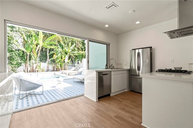 a kitchen with sink and large window