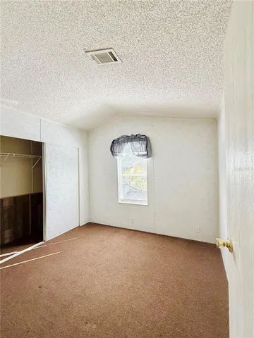 an empty room with a empty space and windows