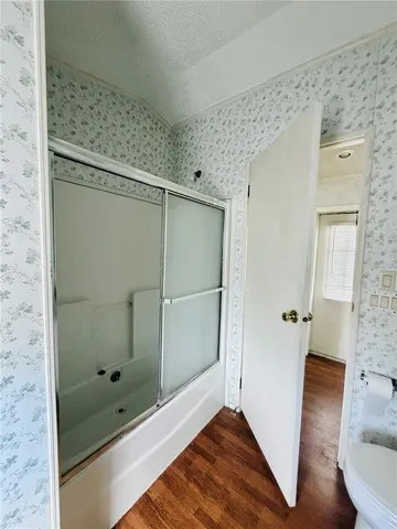 a bathroom with a glass shower door and a sink