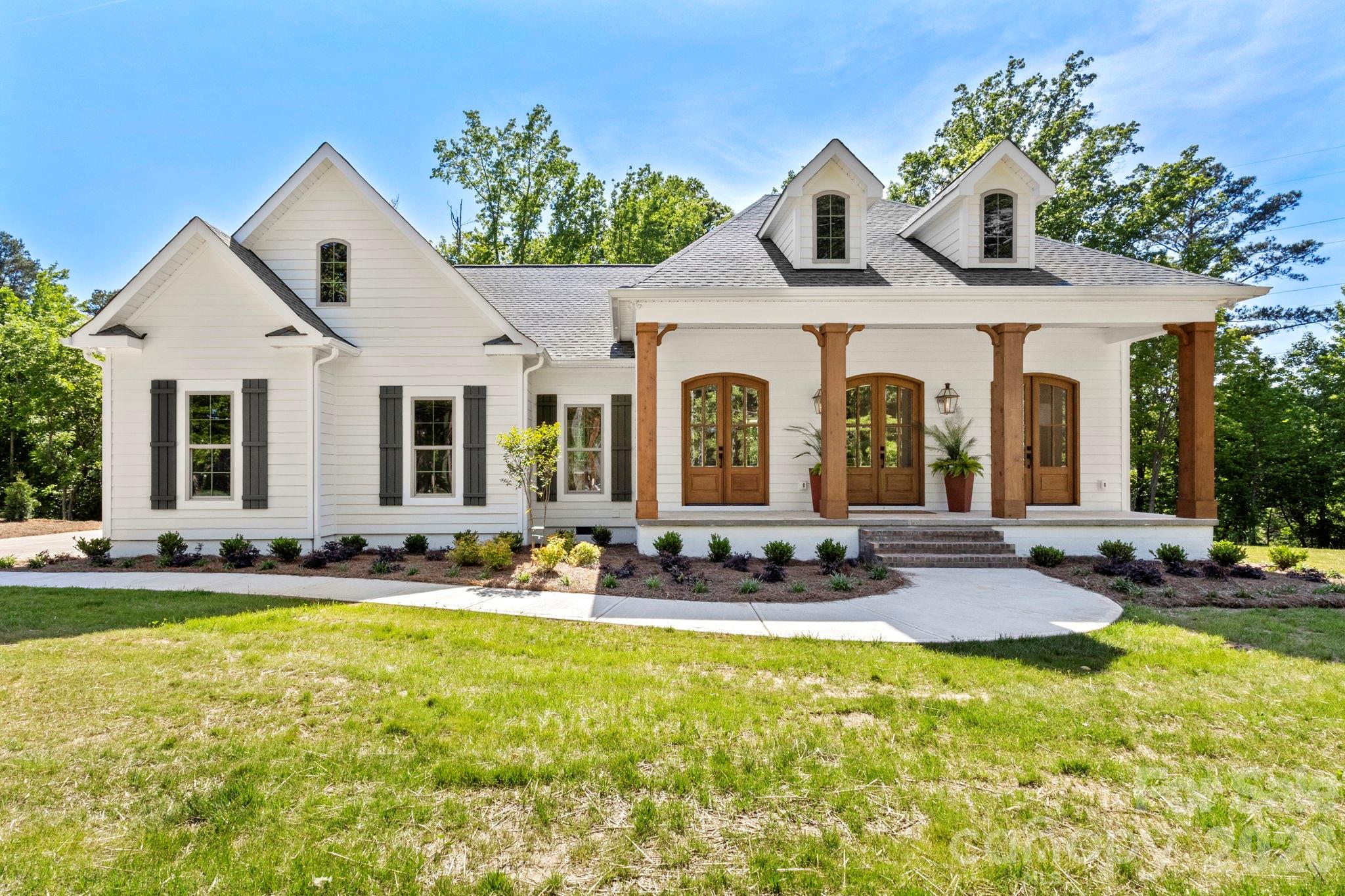 a front view of a house with swimming pool and sitting area