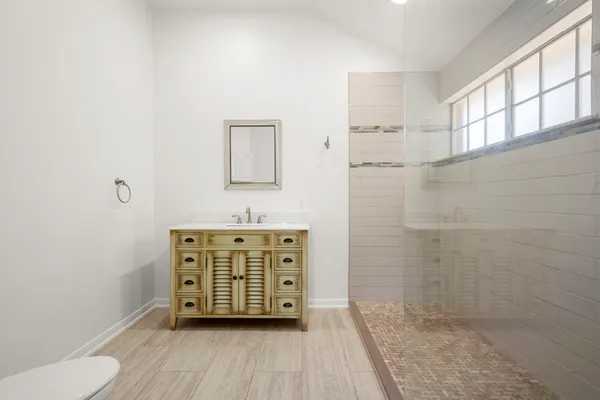 a bathroom with a granite countertop sink toilet and shower
