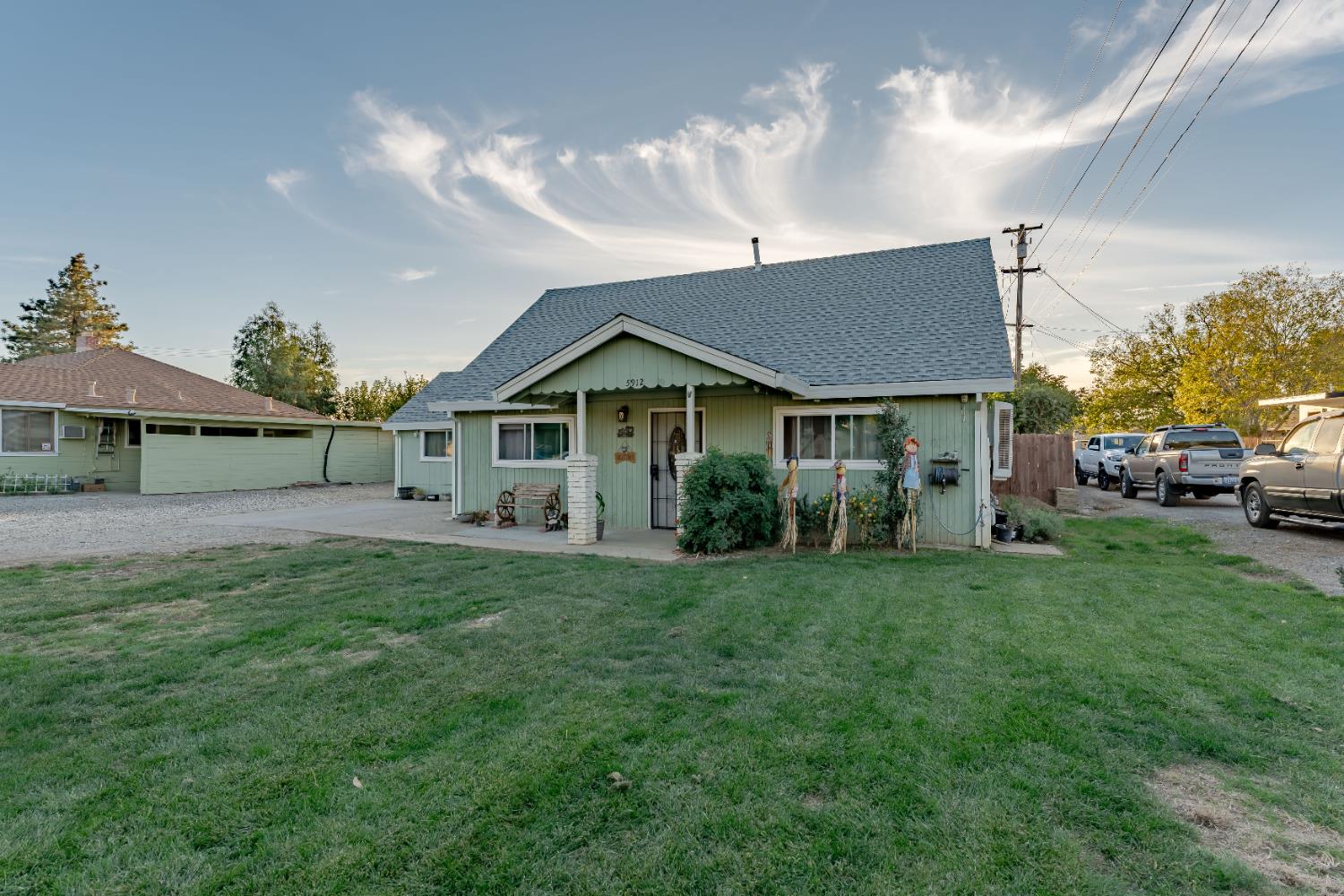 5912 Grove Avenue Marysville, CA 95901 - Photo 1 of 23 a front view of a house with a garden and trees
