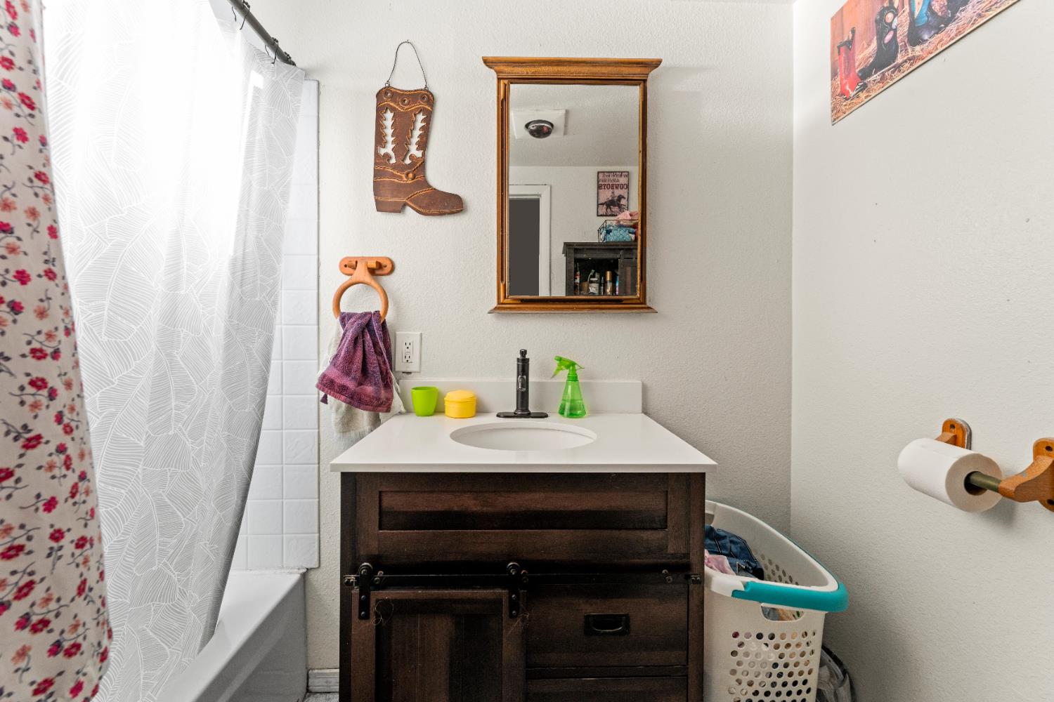 5912 Grove Avenue Marysville, CA 95901 - Photo 13 of 23 a bathroom with a sink and a mirror