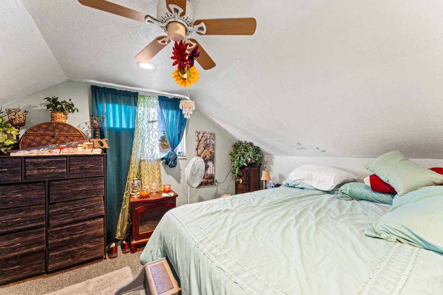 5912 Grove Avenue Marysville, CA 95901 - Photo 15 of 23 a bedroom with a bed and a chandelier